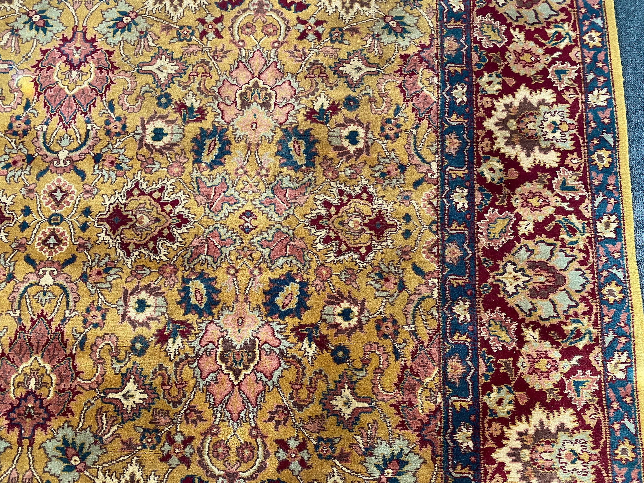 An Agra gold ground carpet with dense palmette field and wide conforming border 360 x 280 cms